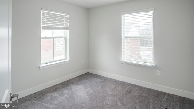 unfurnished room featuring baseboards and carpet flooring