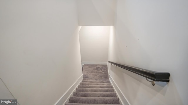 staircase with carpet and baseboards