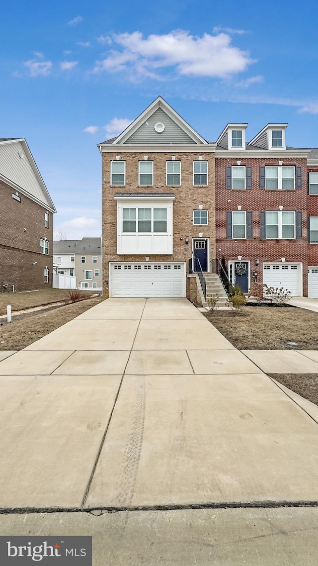 view of front of property with driveway, a garage, and brick siding