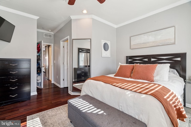 bedroom with visible vents, baseboards, ornamental molding, wood finished floors, and a ceiling fan