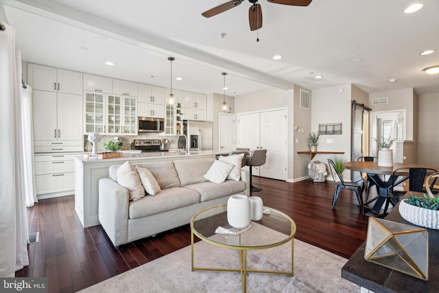 living area with recessed lighting, visible vents, dark wood-style floors, and a ceiling fan