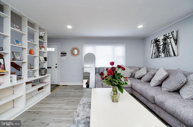 living room with light wood-style flooring, baseboards, and recessed lighting