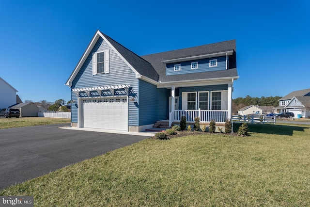 view of front of home featuring a porch, aphalt driveway, a shingled roof, fence, and a front lawn