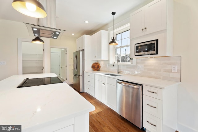 kitchen featuring white cabinetry, pendant lighting, and stainless steel appliances