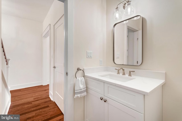 bathroom featuring vanity, baseboards, and wood finished floors