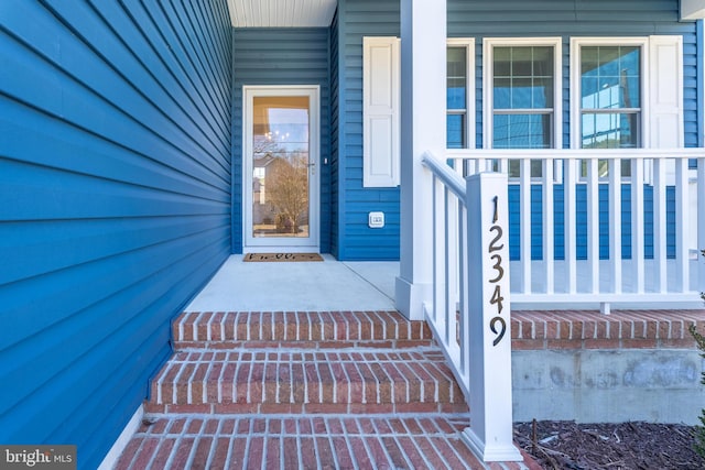 view of exterior entry featuring a porch