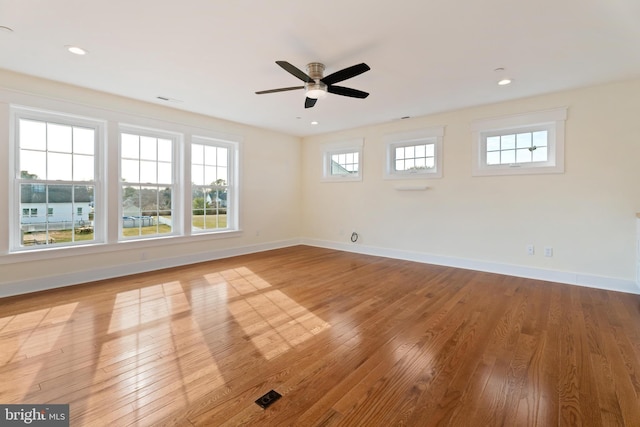 unfurnished room featuring a ceiling fan, recessed lighting, light wood-style flooring, and baseboards