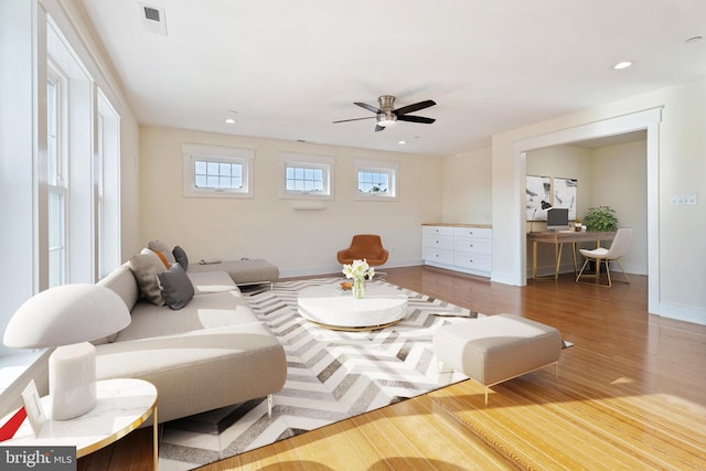 living room featuring baseboards, wood finished floors, visible vents, and recessed lighting