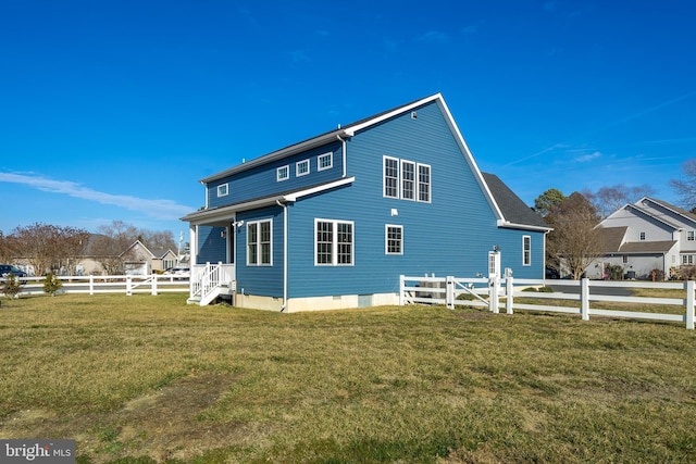 rear view of property featuring crawl space, a lawn, and fence