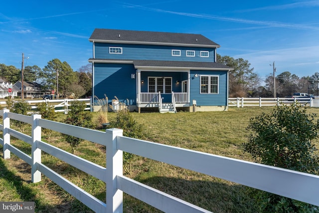 view of front of house with covered porch, a fenced front yard, and a front yard