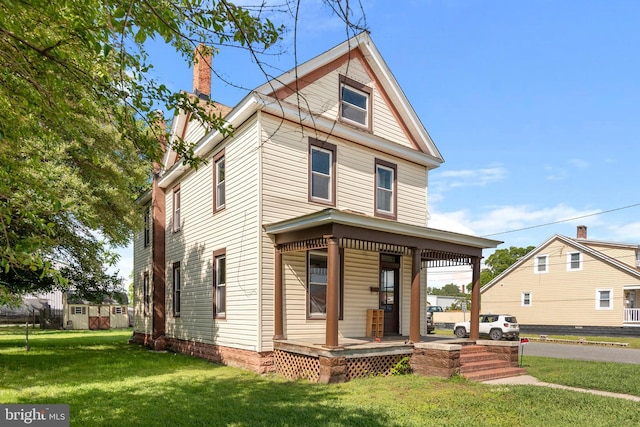 201 Washington St, Cambridge, MD 21613 - view of front facade featuring a porch, a chimney, and a front yard