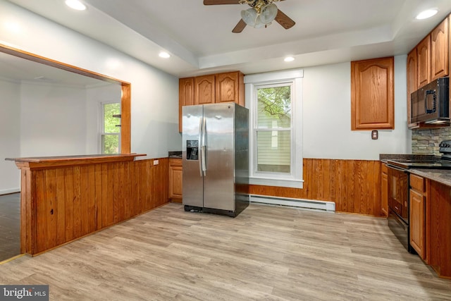 201 Washington St, Cambridge, MD 21613 - kitchen featuring black appliances, baseboard heating, brown cabinets, a peninsula, and recessed lighting