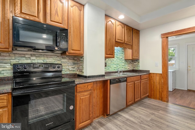 201 Washington St, Cambridge, MD 21613 - kitchen with black appliances, dark countertops, light wood-style floors, a wainscoted wall, and recessed lighting