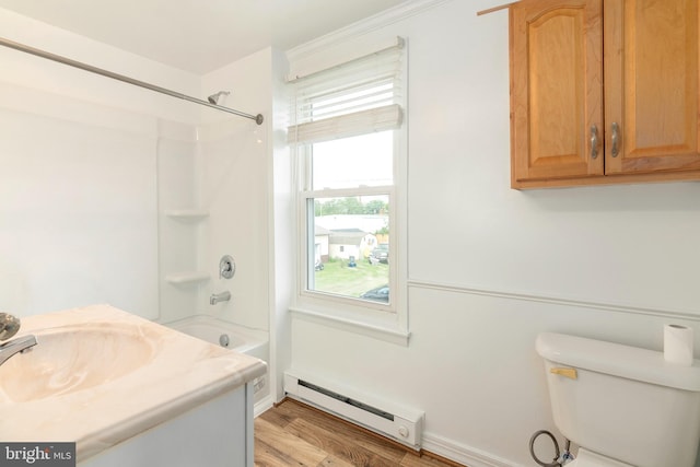 201 Washington St, Cambridge, MD 21613 - full bathroom featuring baseboard heating, bathtub / shower combination, wood finished floors, and vanity