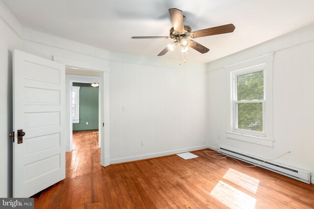 201 Washington St, Cambridge, MD 21613 - empty room with baseboard heating, wood finished floors, and ceiling fan