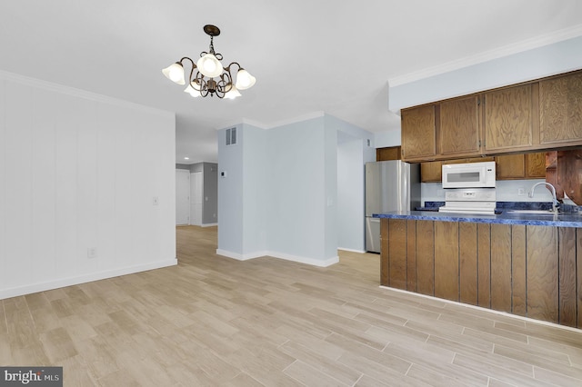 kitchen with white microwave, electric range, ornamental molding, freestanding refrigerator, and dark countertops