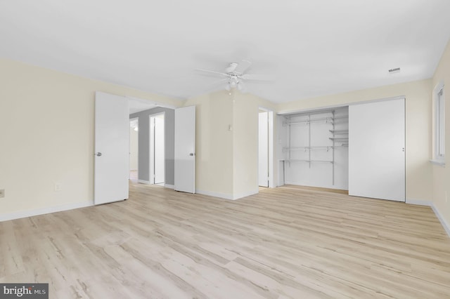 unfurnished bedroom with ceiling fan, a closet, baseboards, and wood finished floors