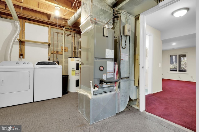 clothes washing area featuring carpet floors, laundry area, water heater, and washer and clothes dryer