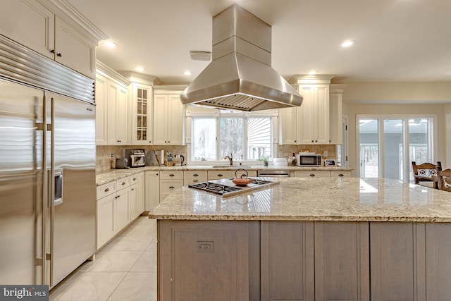 2 Wilderness Dr, Medford, NJ 08055 - kitchen with light stone counters, a sink, stainless steel appliances, island exhaust hood, and backsplash