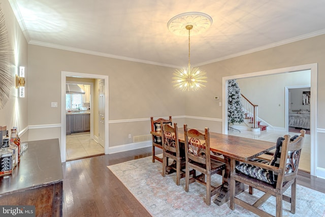 2 Wilderness Dr, Medford, NJ 08055 - dining space featuring an inviting chandelier, crown molding, stairs, and wood finished floors