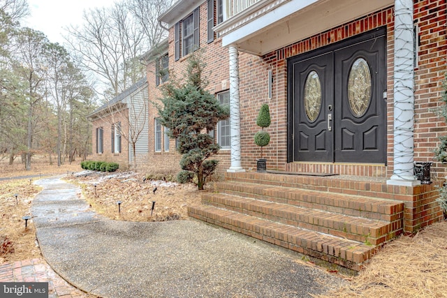 property entrance featuring brick siding