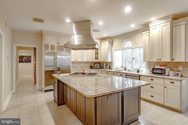 2 Wilderness Dr, Medford, NJ 08055 - kitchen with tasteful backsplash, light stone countertops, stainless steel appliances, and island range hood