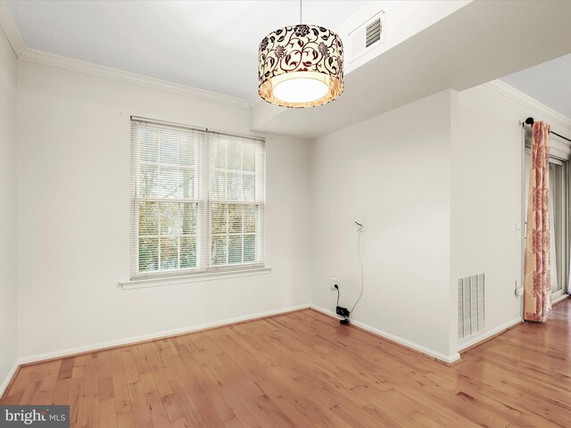 interior space featuring crown molding, visible vents, and light wood-style floors