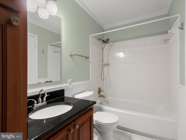 bathroom with wainscoting, toilet, ornamental molding, bathtub / shower combination, and vanity