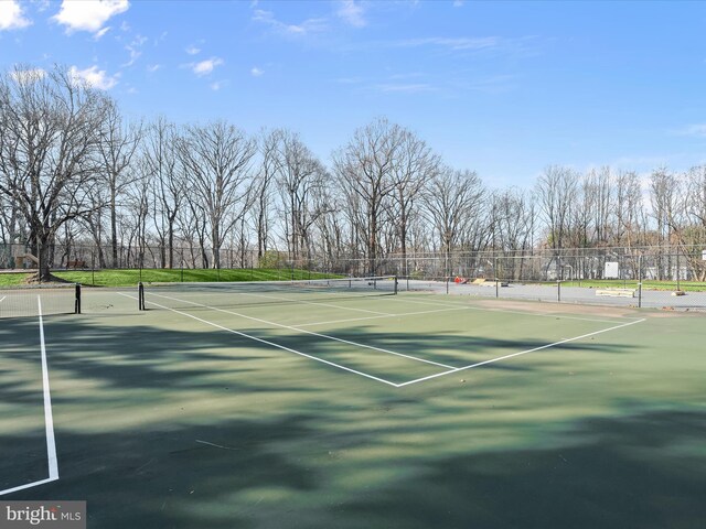 view of sport court featuring fence