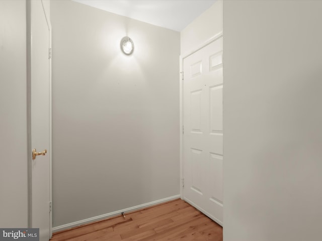 interior space featuring baseboards and light wood-style floors