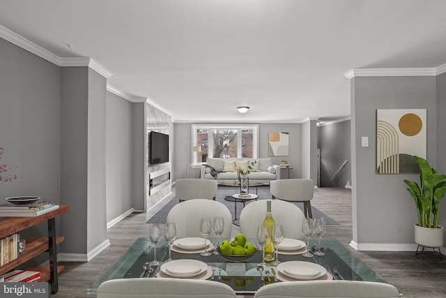 dining area featuring baseboards, wood finished floors, and crown molding