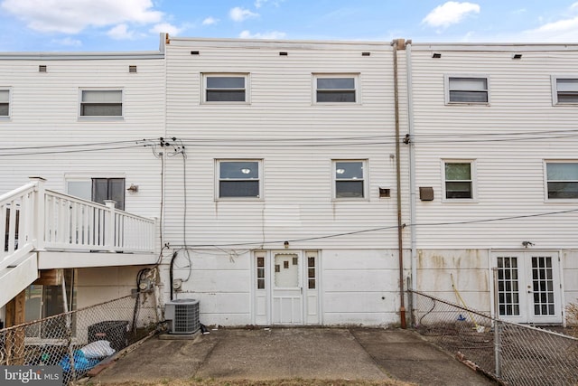 back of house featuring french doors, central AC unit, and fence