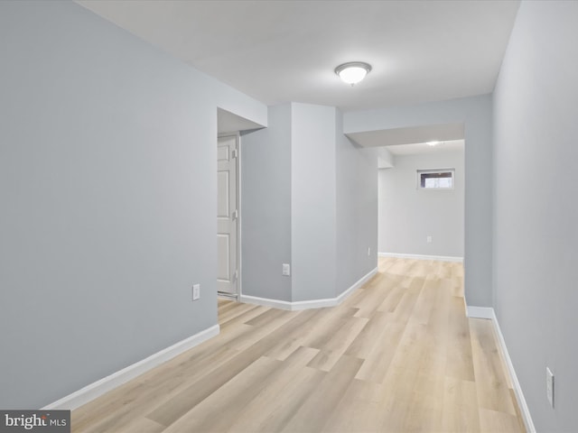 spare room with light wood finished floors and baseboards