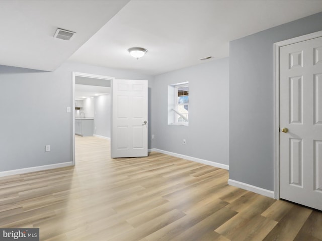 unfurnished bedroom with light wood-style floors, baseboards, and visible vents