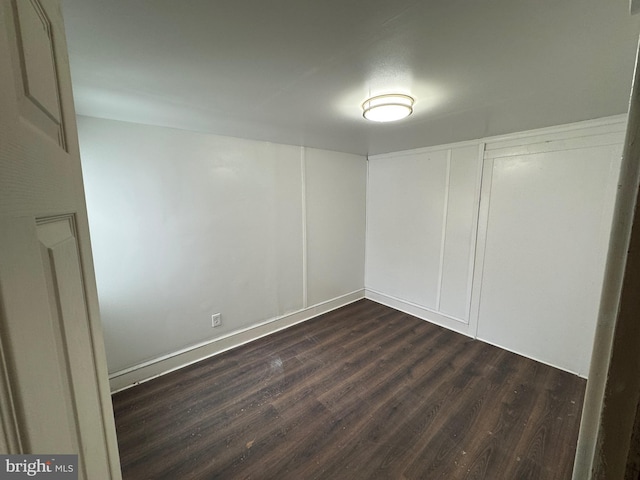 empty room featuring dark wood finished floors