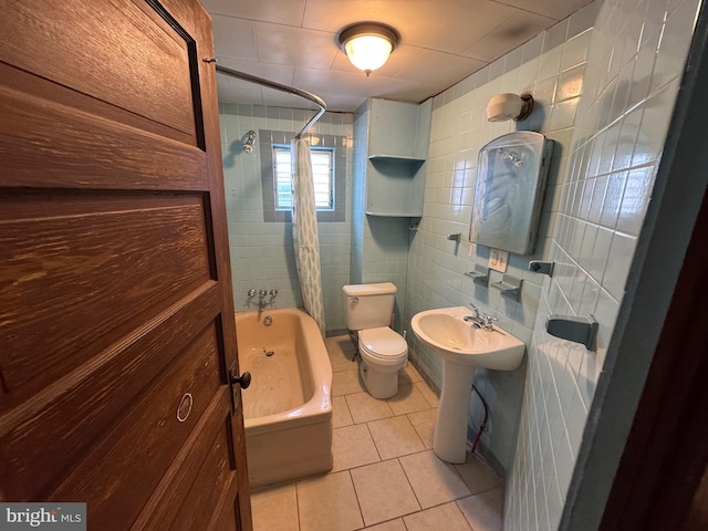 full bathroom with tile patterned flooring, shower / tub combo with curtain, tile walls, and toilet