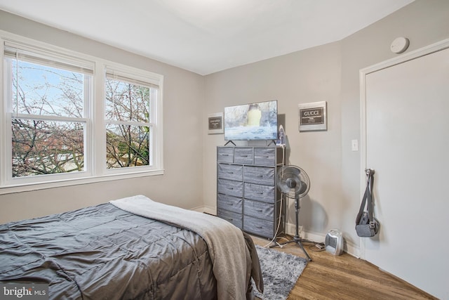 bedroom with wood finished floors and baseboards