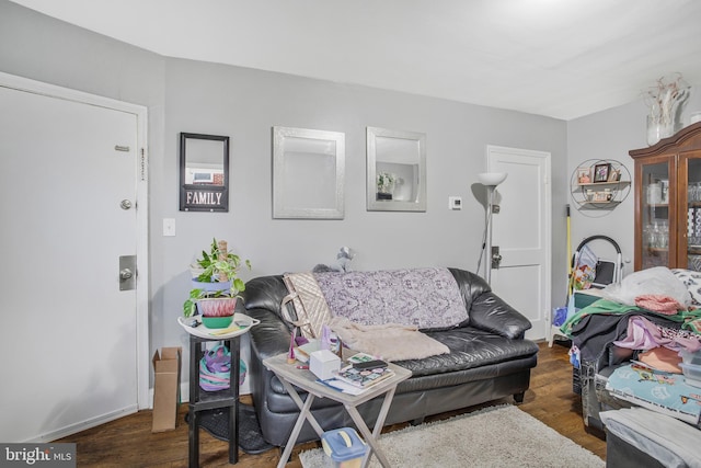 living room with baseboards and wood finished floors