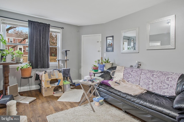 living area with wood finished floors and baseboards