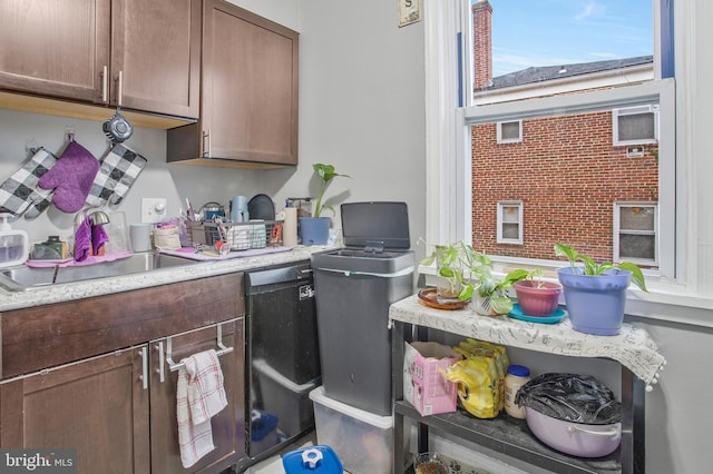 kitchen featuring light countertops and a sink