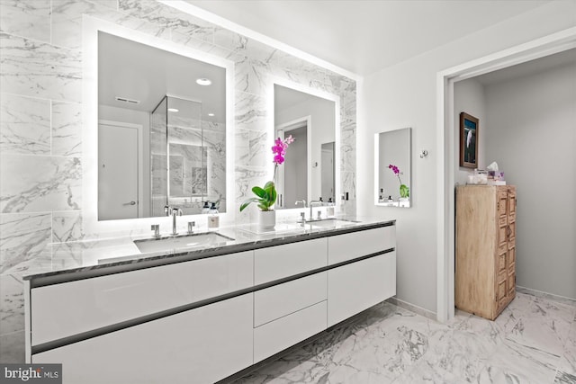 bathroom with double vanity, marble finish floor, a sink, and recessed lighting