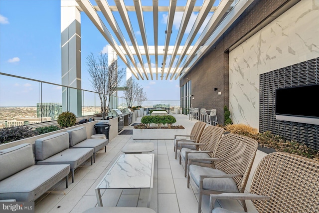 view of patio / terrace with an outdoor living space, an outdoor kitchen, and a pergola