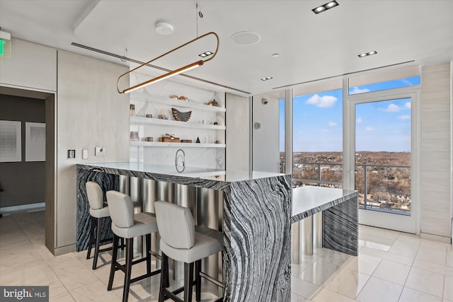 kitchen with expansive windows, open shelves, and a kitchen breakfast bar