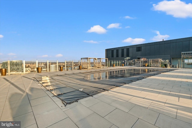 view of pool with a patio area and fence