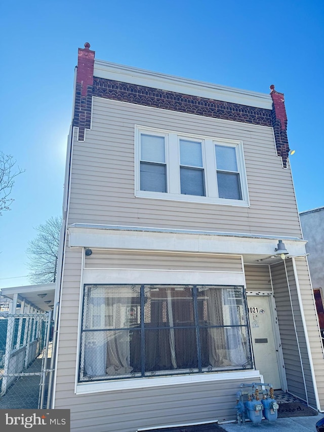 exterior space with a chimney and fence