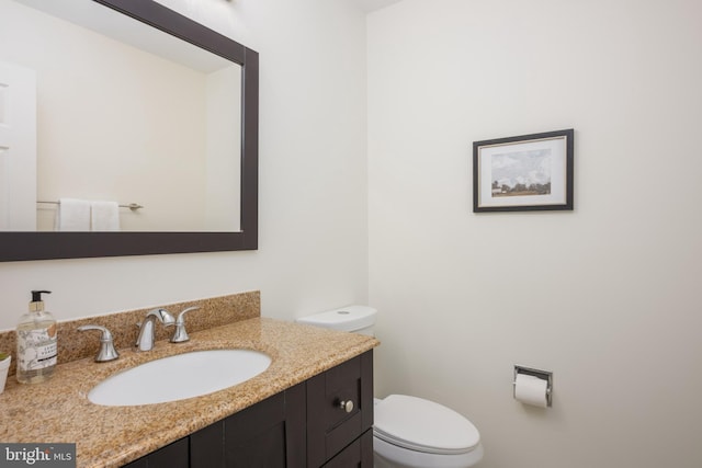 bathroom featuring toilet and vanity