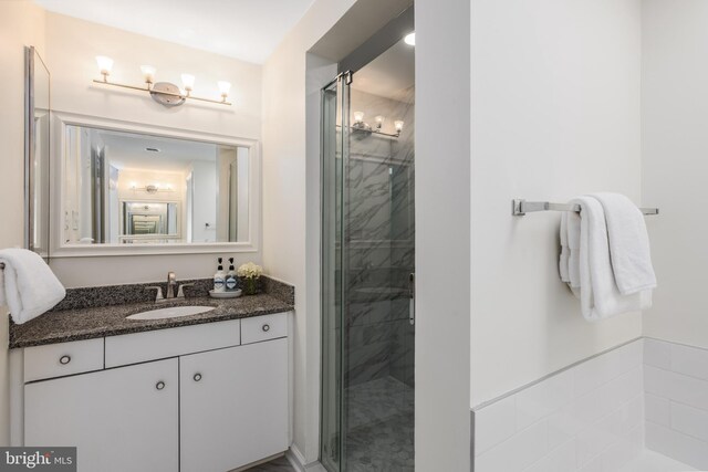 full bathroom with vanity and a stall shower