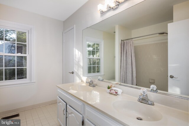 full bathroom featuring tile patterned floors, baseboards, visible vents, and a sink