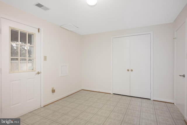 empty room with light floors, visible vents, and baseboards