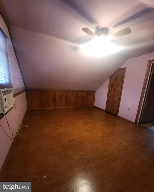 bonus room with lofted ceiling, cooling unit, dark wood finished floors, and a ceiling fan